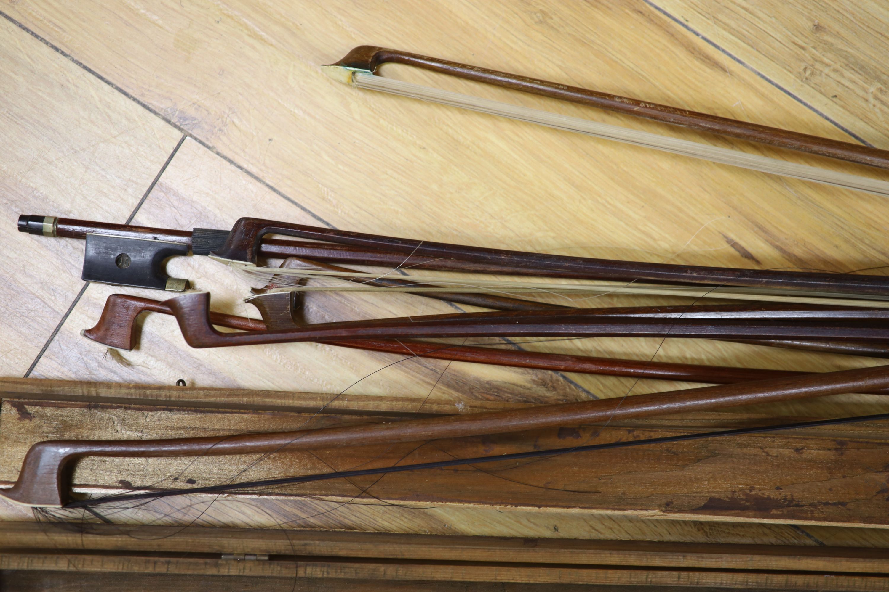 A quantity of violin bows and box, together with a print